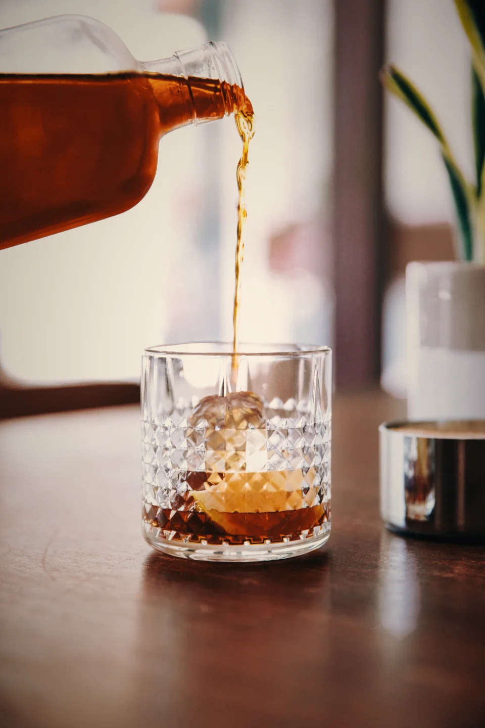 Whiskey being poured into a crystal glass